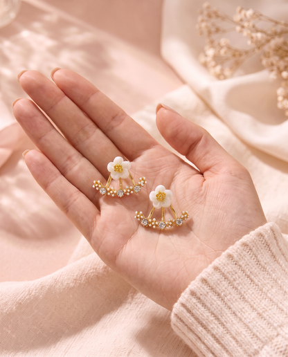 Daffodil Earrings held in the palm