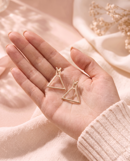 Rhea Earrings held in the palm